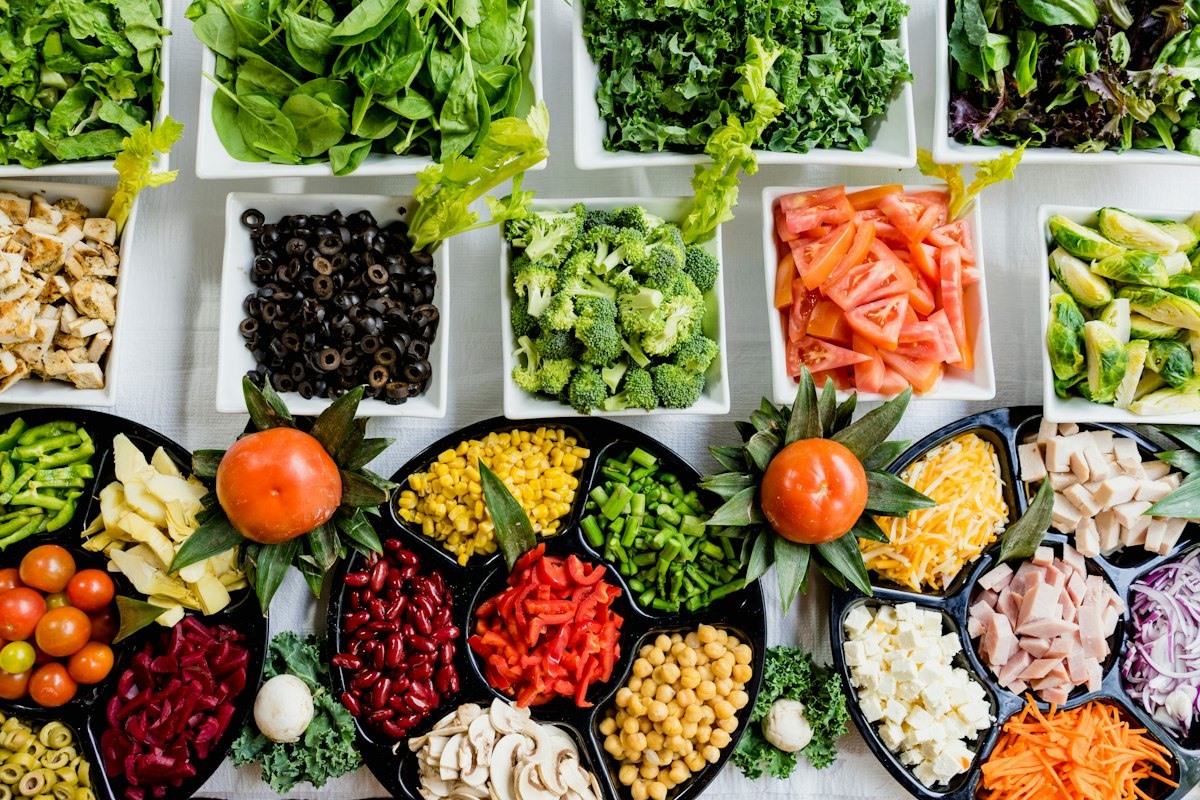 Colorful whole foods rich in natural fiber including chia seeds, rolled oats, berries, lentils, and fresh greens